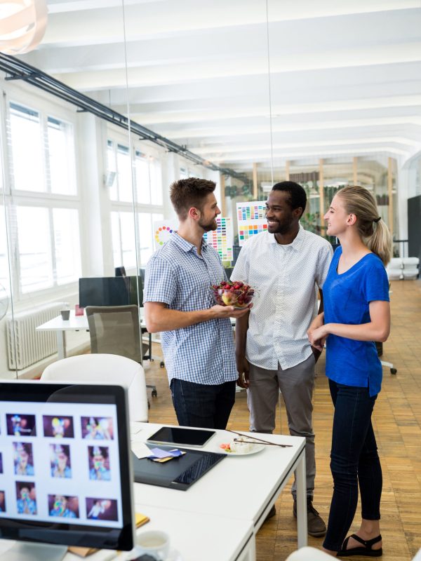 Group of graphic designers interacting with each other in office